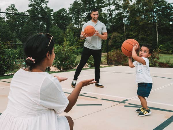 A family playing basketball on a court