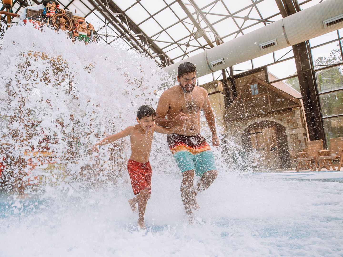 father and son playing in a pool