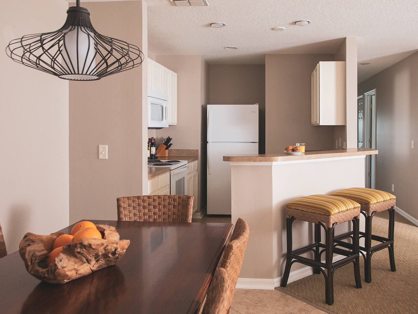 Kitchen and dining table in a three-bedroom villa at Orlando Breeze Resort.