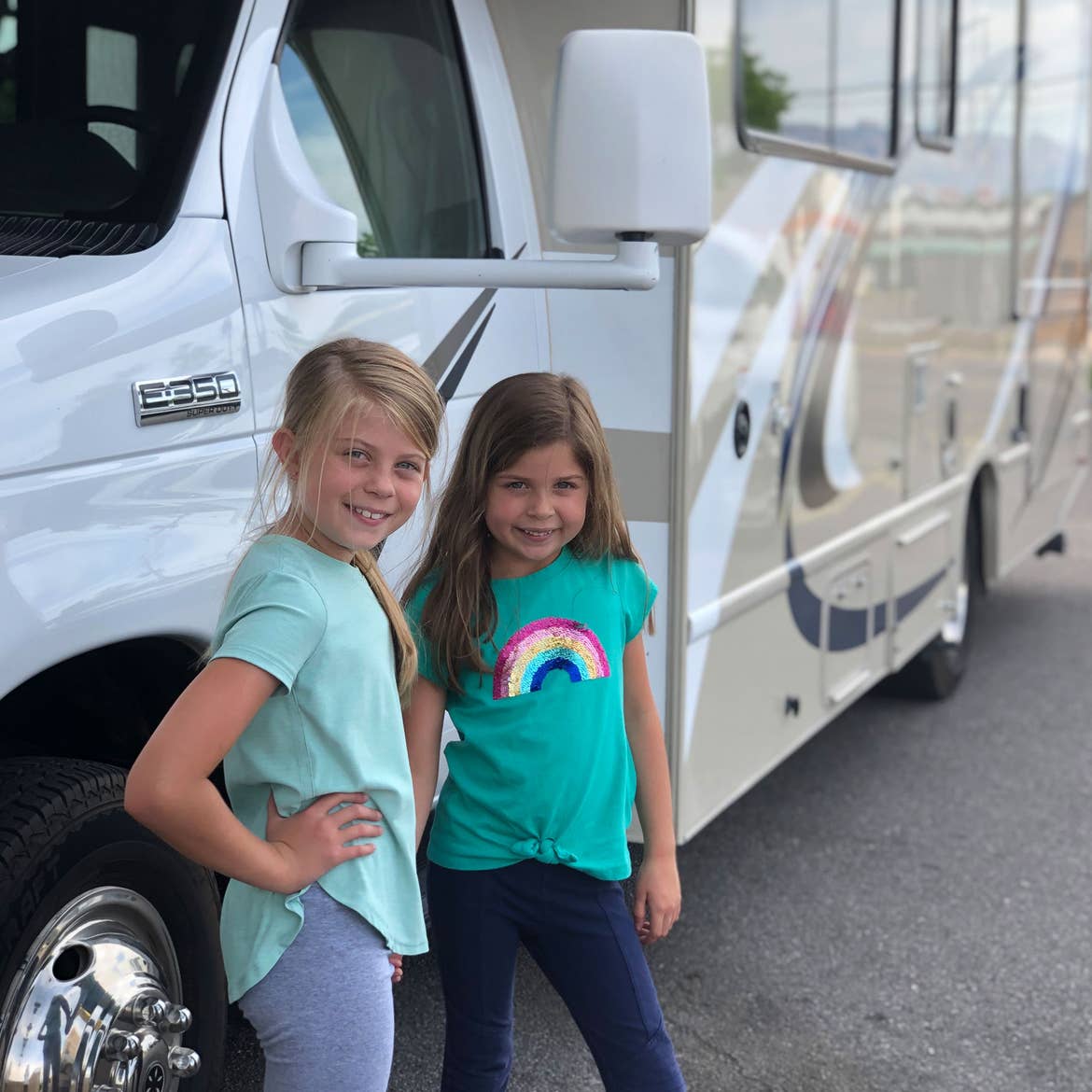 Kyndall and Kyler stand in front of the RV rental.