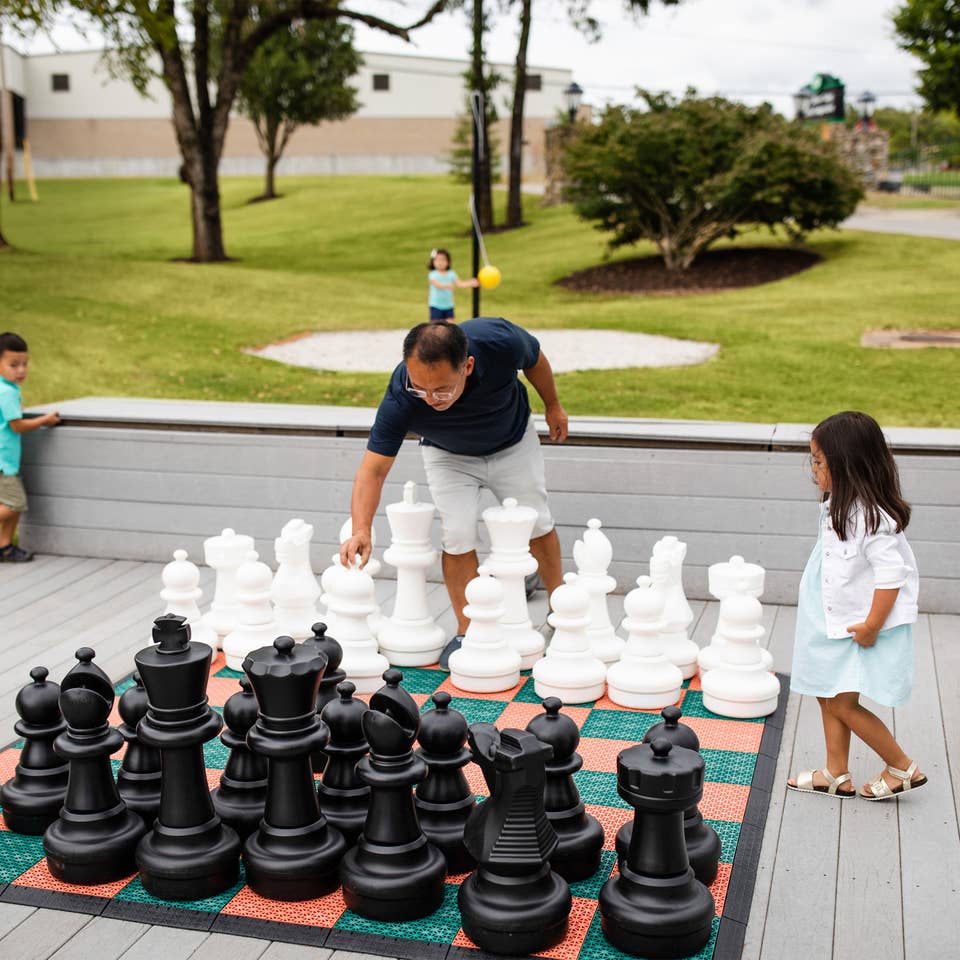 Family playing life-sized chess at Holiday Hills Resort in Branson, Missouri.