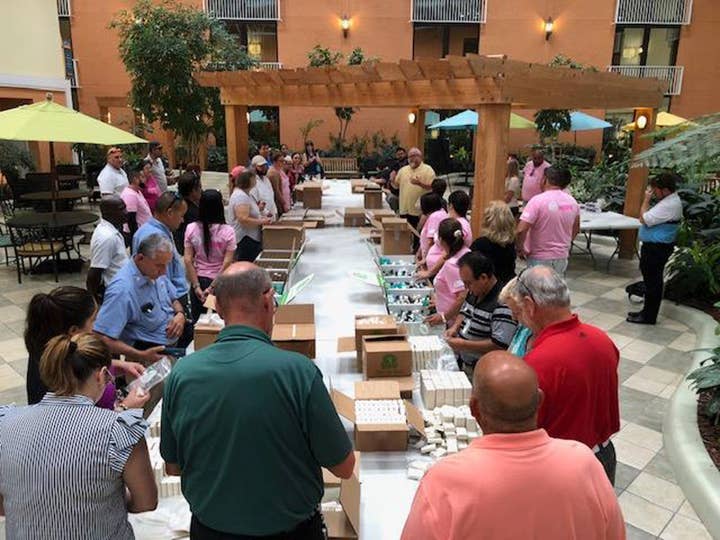 Volunteers sorting cleaning and hygiene products into boxes