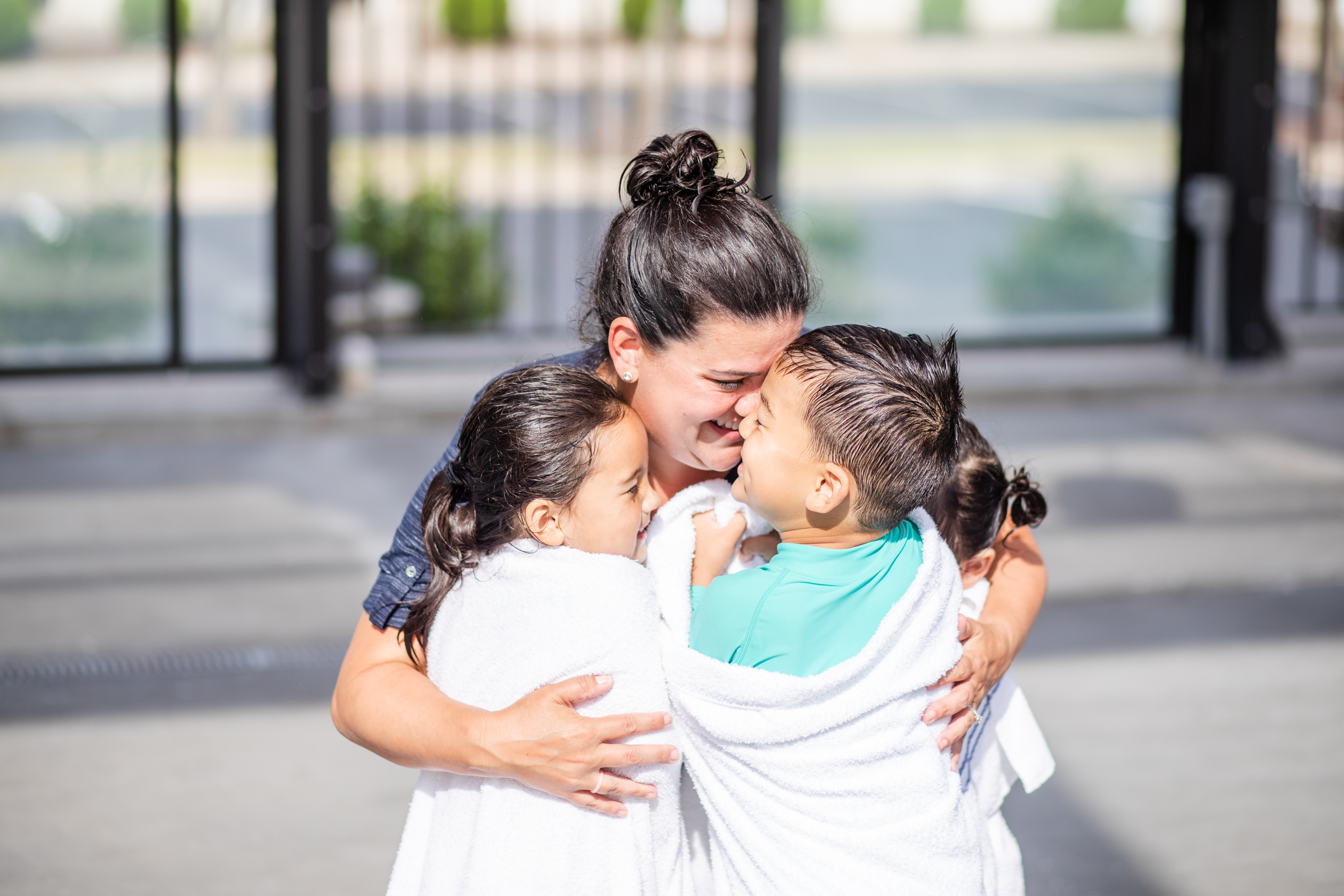 Angelica hugging her kids by the pool