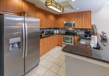 Full kitchen with stainless steel appliances in a three-bedroom villa at Sunset Cove Resort in Marco Island, Florida