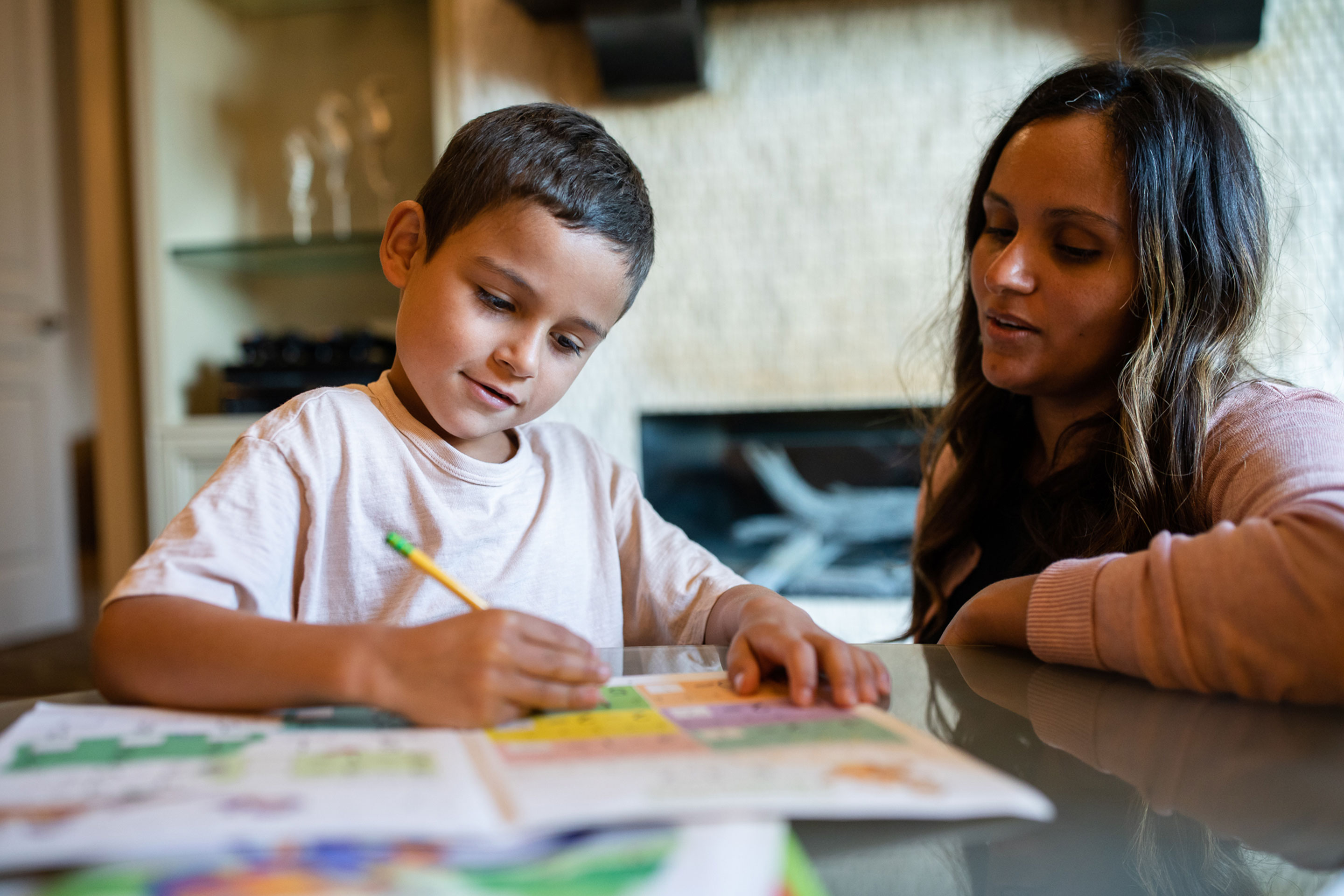 Brenda (right) helps her son (left) with his homework assignments.