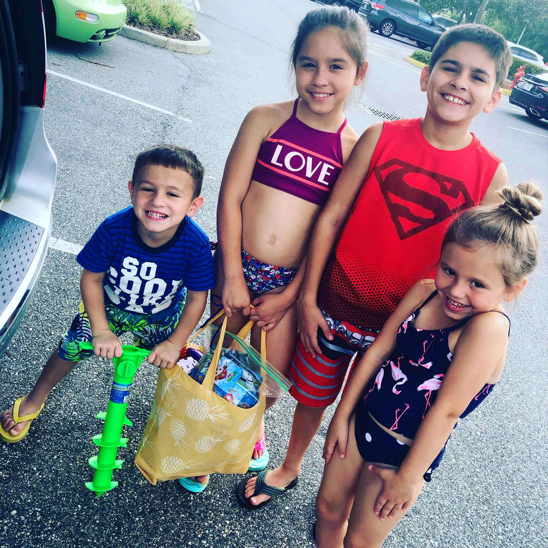 Featured Member, Sara Perez's family stands with two masked HICV Team Members outside of Orange Lake Resort.