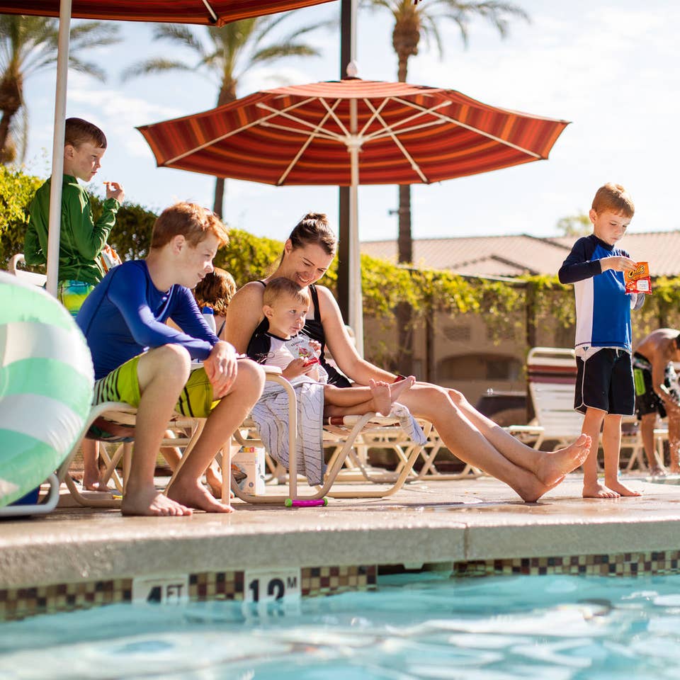 Family by the pool at Scottsdale Resort in Scottsdale, Arizona.
