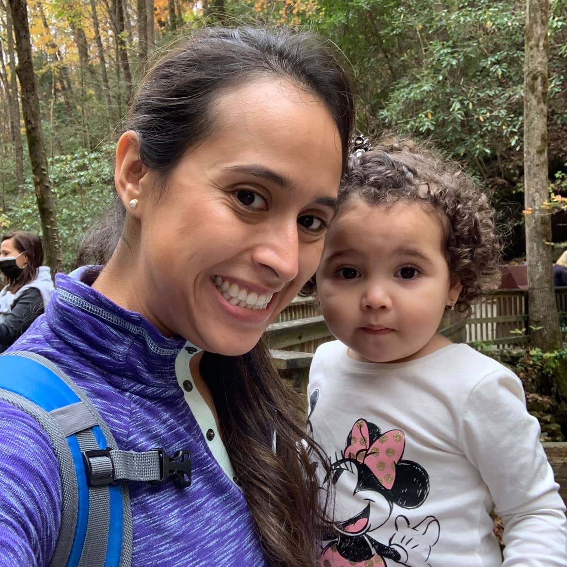 Featured author, Andrea Beltran (left), poses with her niece (right) surrounded by dropped fall foliage.