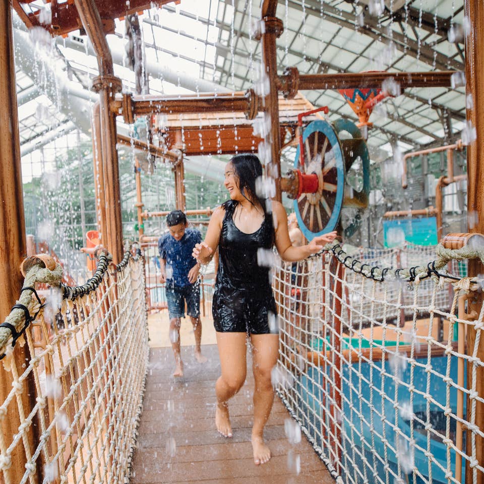 Two kids walking through waterpark at Villages Resort in Flint, Texas.