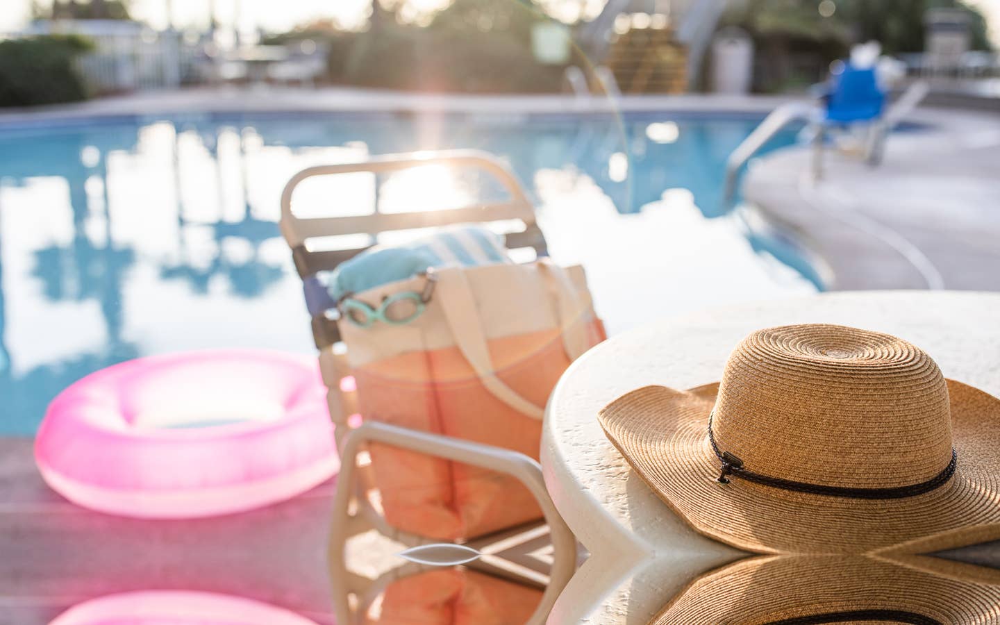Jennifer's hat sits on a table with swimwear next to the poolside of a Holiday Inn Club Vacation Resort.