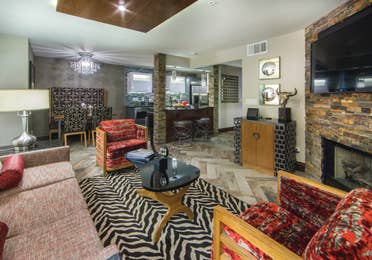 Living room, dining area, and kitchen in a two-bedroom Signature Villa at Desert Club Resort in Las Vegas