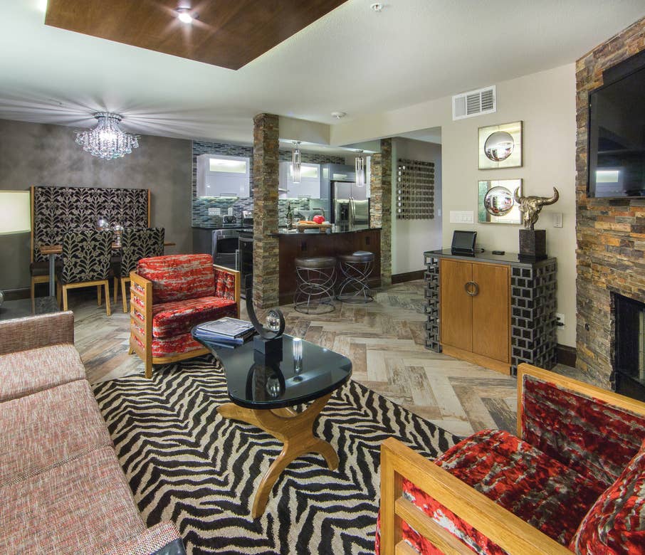 Living room, dining area, and kitchen in a two-bedroom Signature Villa at Desert Club Resort in Las Vegas