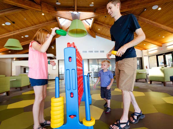 Family playing Connect Four at Scottsdale Resort in Arizona.