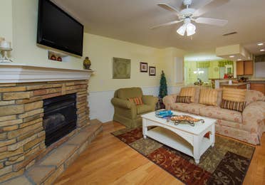 Living room with fireplace in a two-bedroom presidential villa at the Holiday Hills Resort in Branson Missouri.