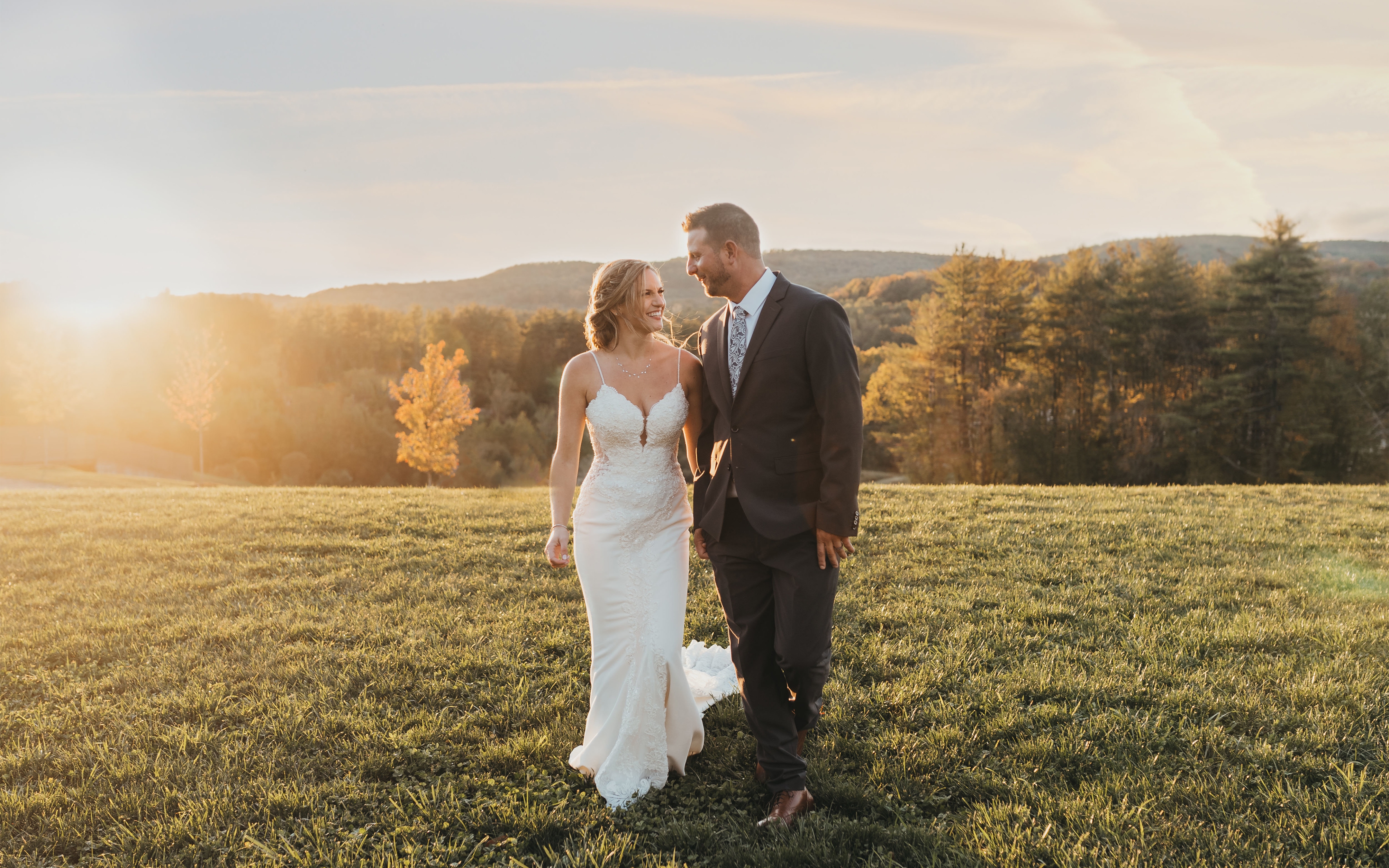 Bride and groom standing on hill after a wedding at Mount Ascutney Resort in Brownsville, Vermont.