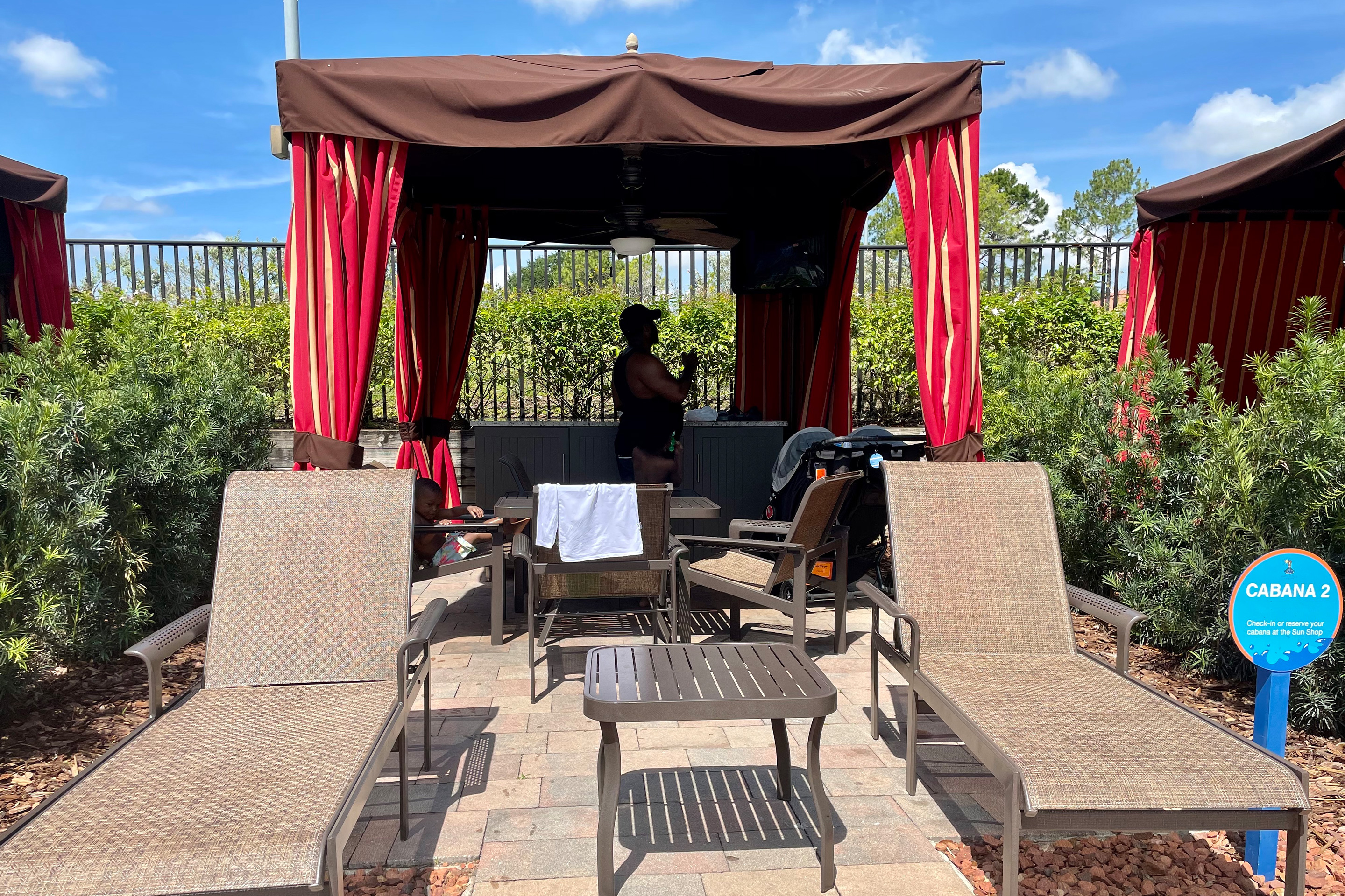 Krystin Godfrey's husband, Phillip, sets up various poolside items in the shade of our River Island cabana.
