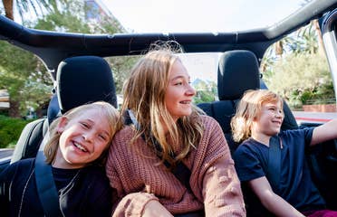 The Haby kids riding in the backseat of an open-top Jeep down the Vegas strip.