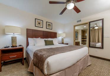 Master bedroom with king bed and attached bathroom in a three-bedroom villa at Scottsdale Resort