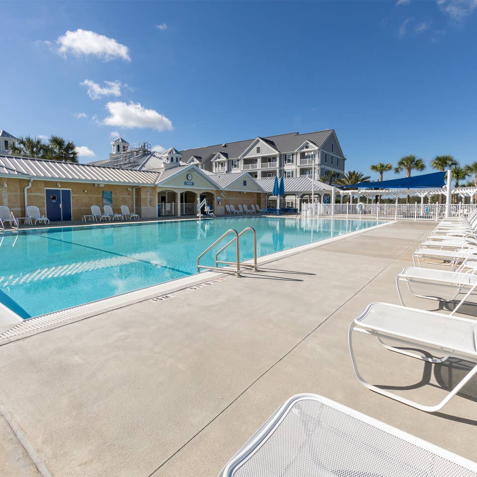 Outdoor pool with lounge chairs at Orlando Breeze Resort near Orlando, Florida.