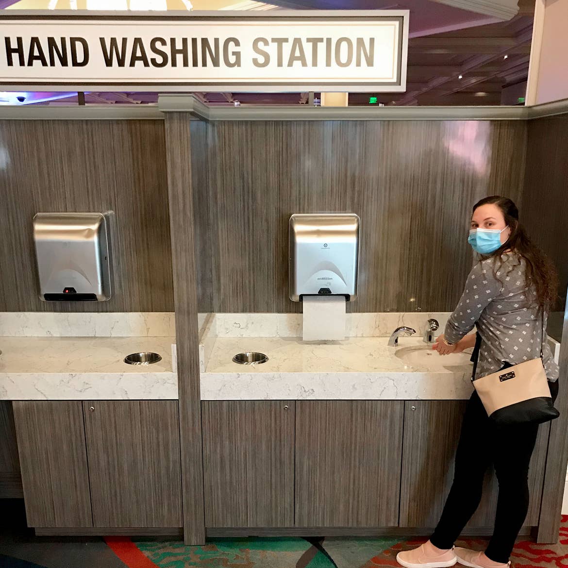 Ashley washes her hands at a 'Hand Washing Station' on the main floor of the casino.