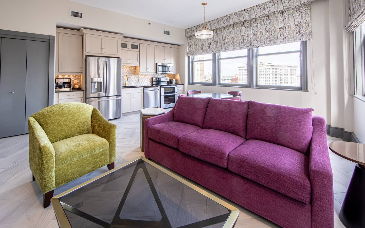 Living room and kitchen in a one-bedroom Signature Collection villa at New Orleans Resort in Louisiana.
