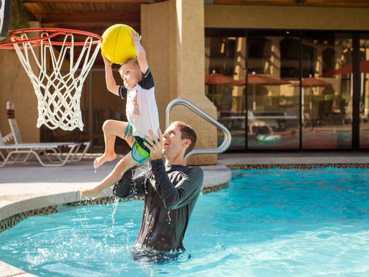 Adult and child playing pool basketball at Scottsdale Resort in Scottsdale, Arizona