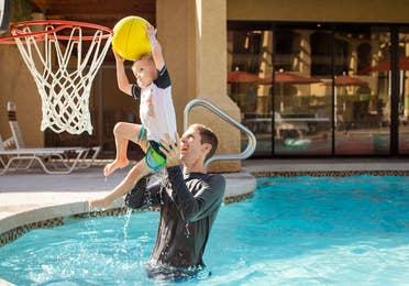 Adult and child playing pool basketball at Scottsdale Resort in Scottsdale, Arizona