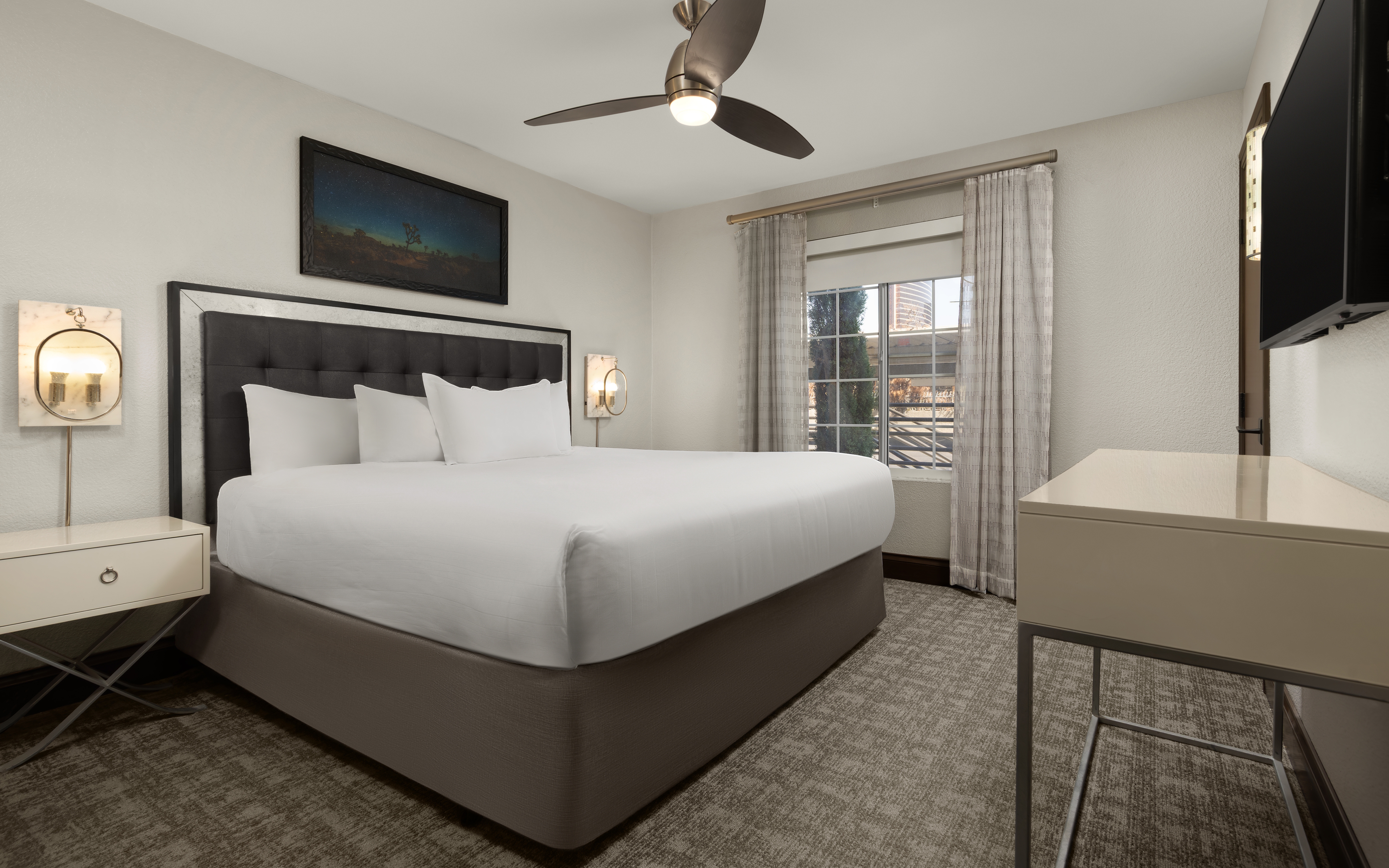 Stylish bedroom with elegant lighting and a plush king bed.
