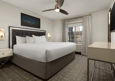 Stylish bedroom with elegant lighting and a plush king bed.