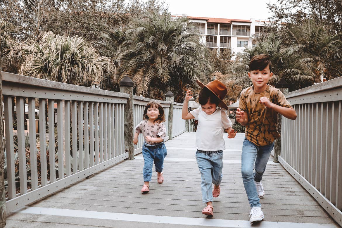 Featured contributor, Mia St. Clair's children, Poppy Bleu (left) Roux (middle) and Grey (right), run across the boardwalk at our Orange Lake Resort in Orlando, FL.