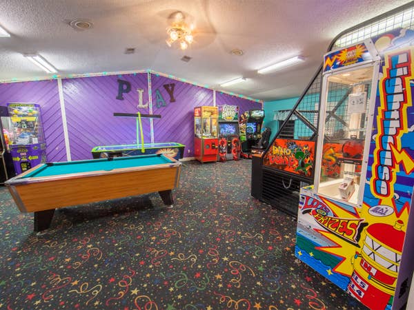 Arcade with pool table, arcade games and air hockey at Holly Lake Resort in Holly Lake Ranch, Texas.