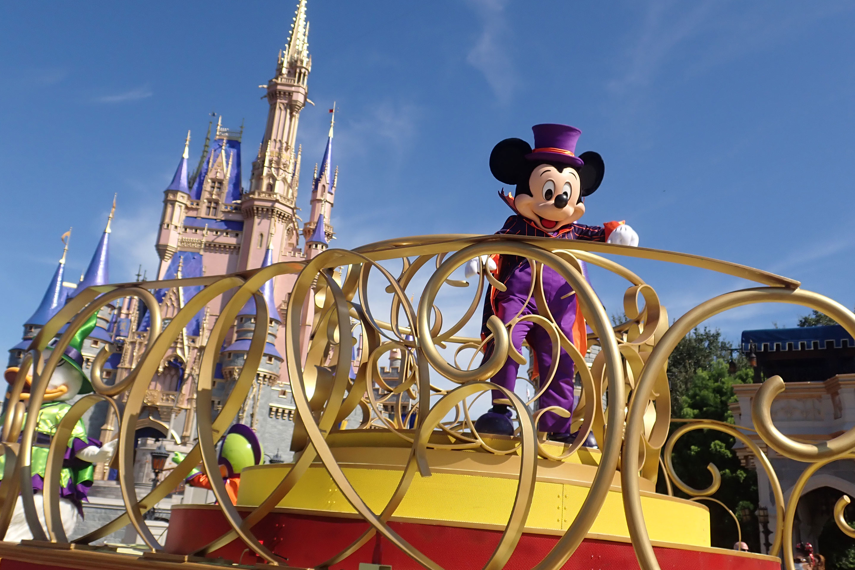 Mickey wearing a Halloween costume in front of Cinderella's Castle at Magic Kingdom at the Not-So-Scary Character Cavalcade at Walt Disney World.