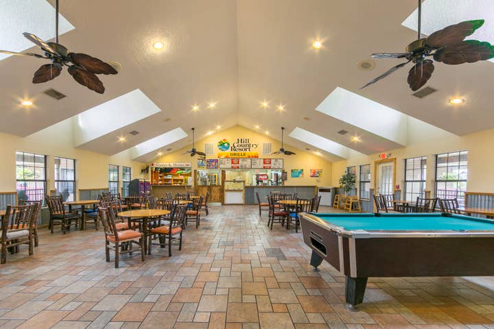 Activities Room with pool table, seating, and Grille at Hill Country Resort in Canyon Lake, Texas