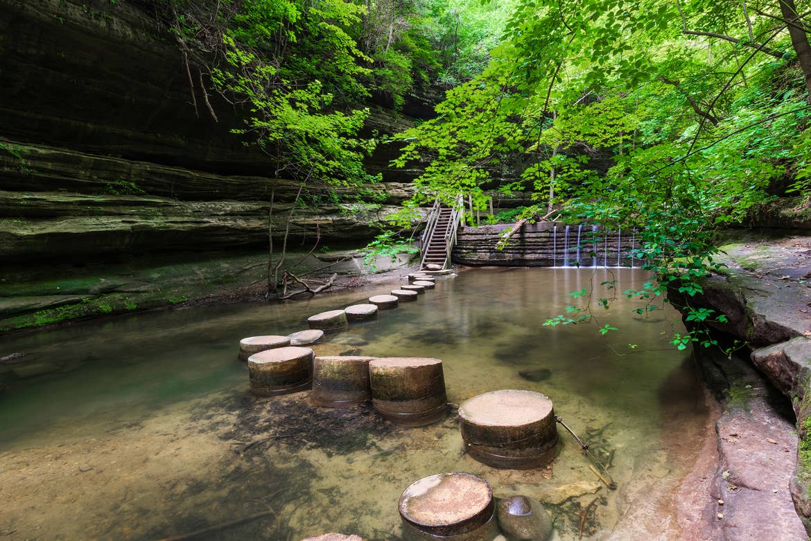 The concrete stepping stones across the pond lead to a secret staircase at Matthiessen State Park, Illinois.