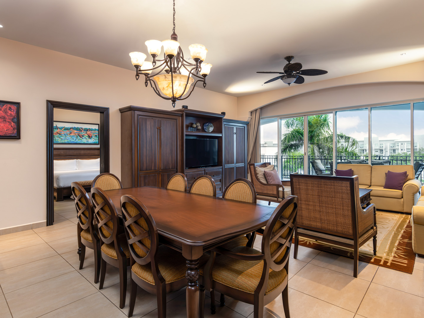 Breezy living and dining area with balcony and resort views.