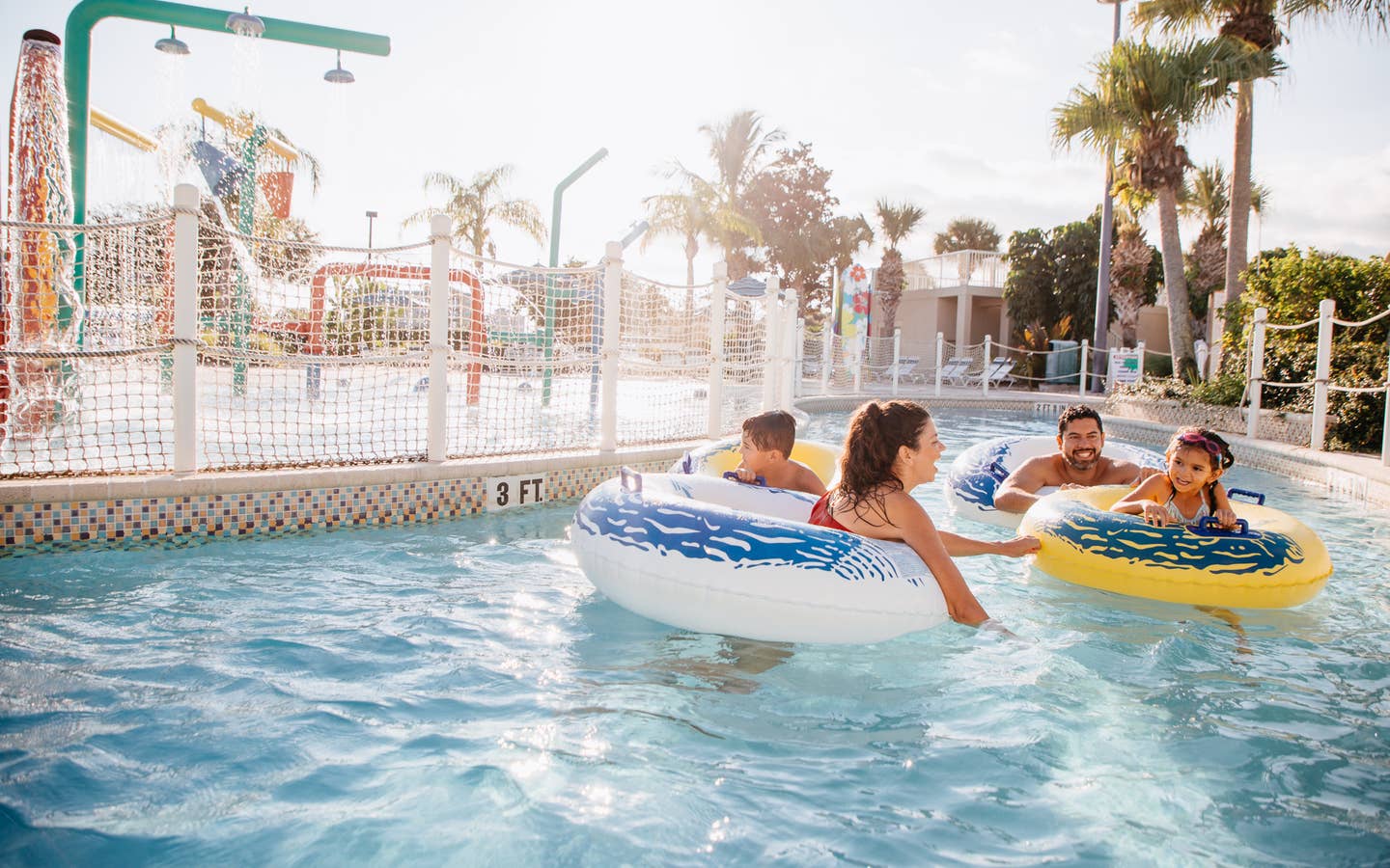 Family of four floating down lazy river at Cape Canaveral Beach Resort in Florida.