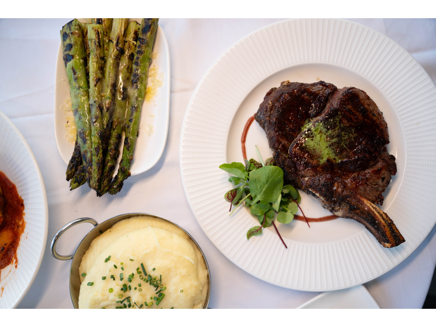 Picture of steak and other food served nicely from the Geneva Chophouse.