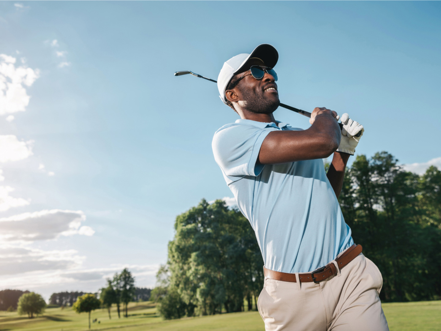 Man swinging a golf club.