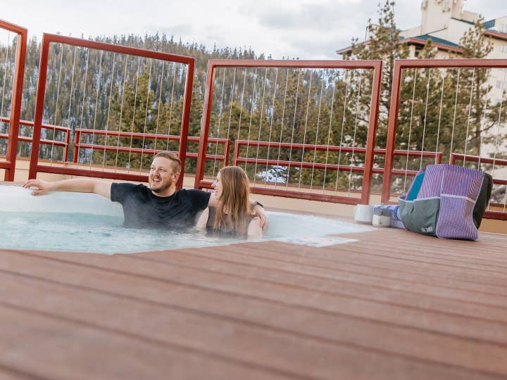Couple sitting in outdoor hot tub at Tahoe Ridge Resort in Stateline, Nevada.
