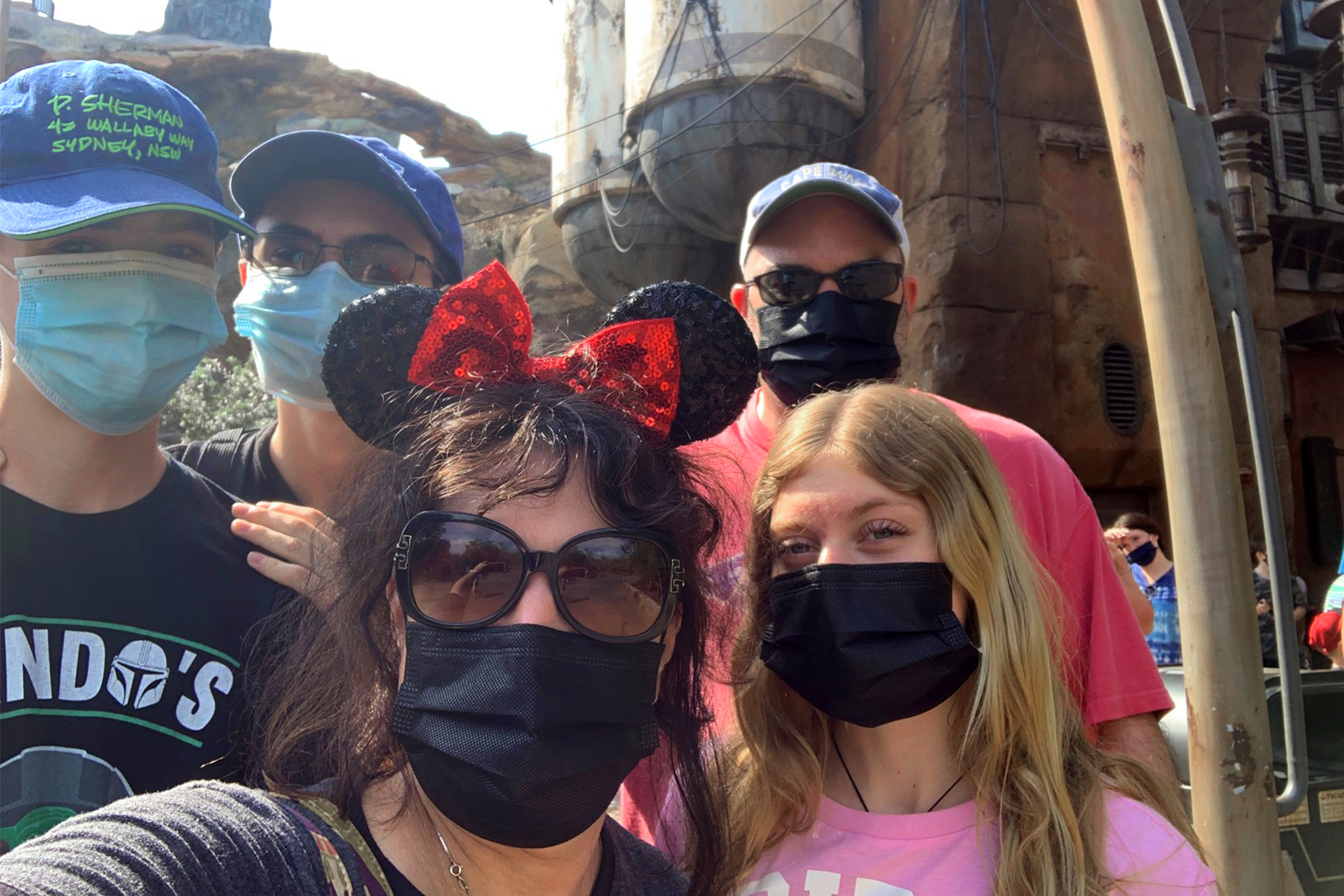 Featured contributor, Jenn Probst (front-middle) and her husband (back-right), two sons (back-left) and niece (front-right) wear masks and Disney based apparel at Galaxy's Edge in Disney's Hollywood Studios at Walt Disney World Resort.