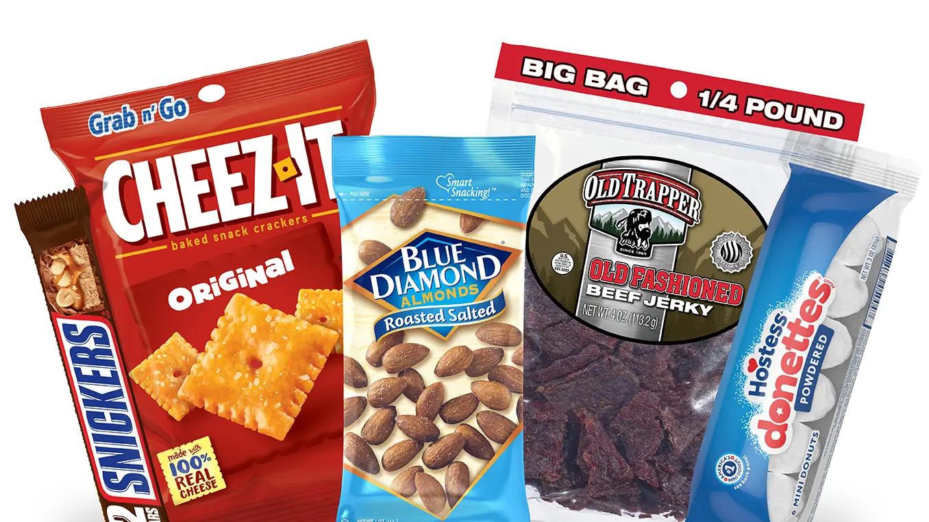 Snack line up of SNICKERS, Cheez-IT, Blue Diamond Almonds, Old Trapper, and Hostess Donettes.
