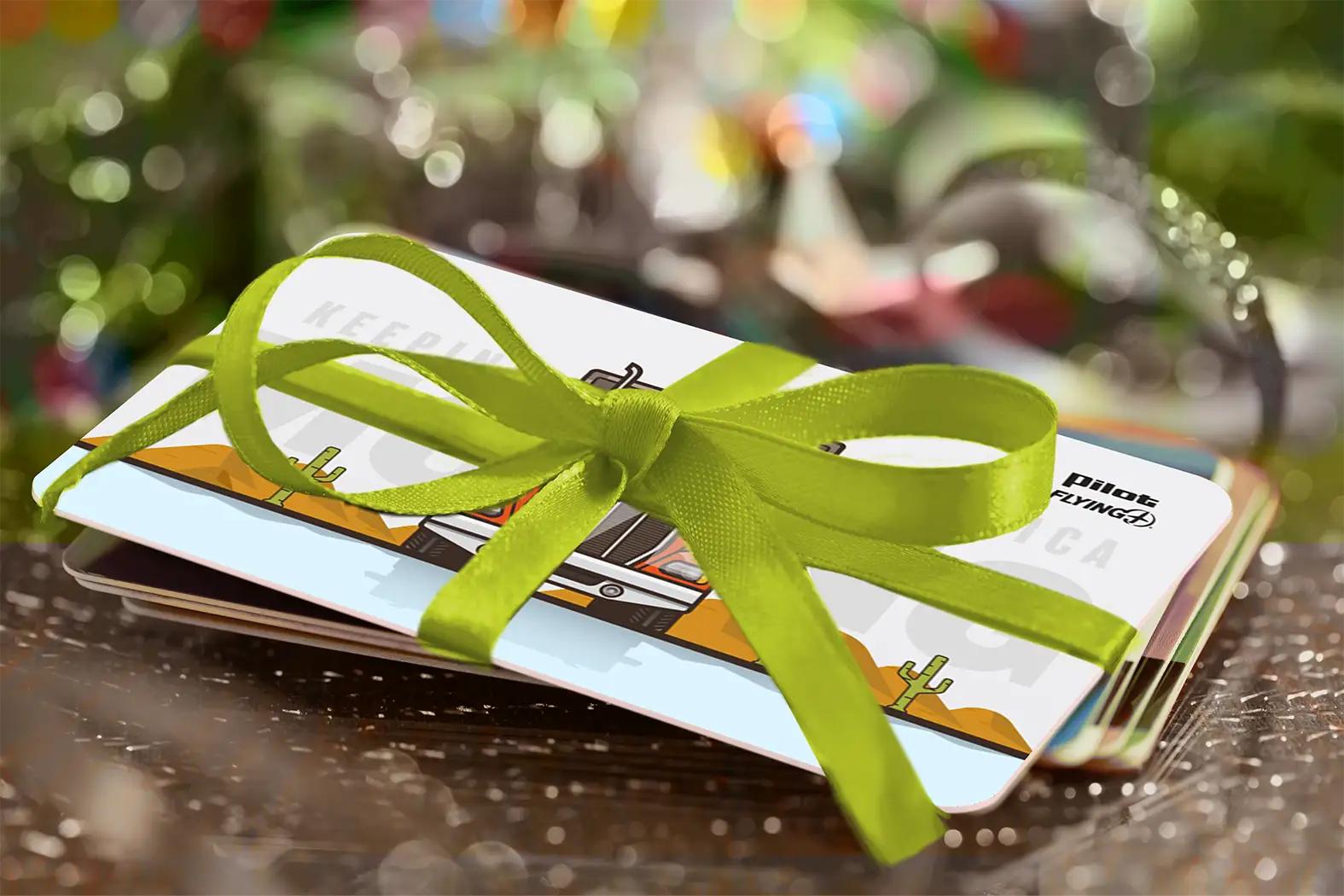 A group of pilot gift cards wrapped with a green bow