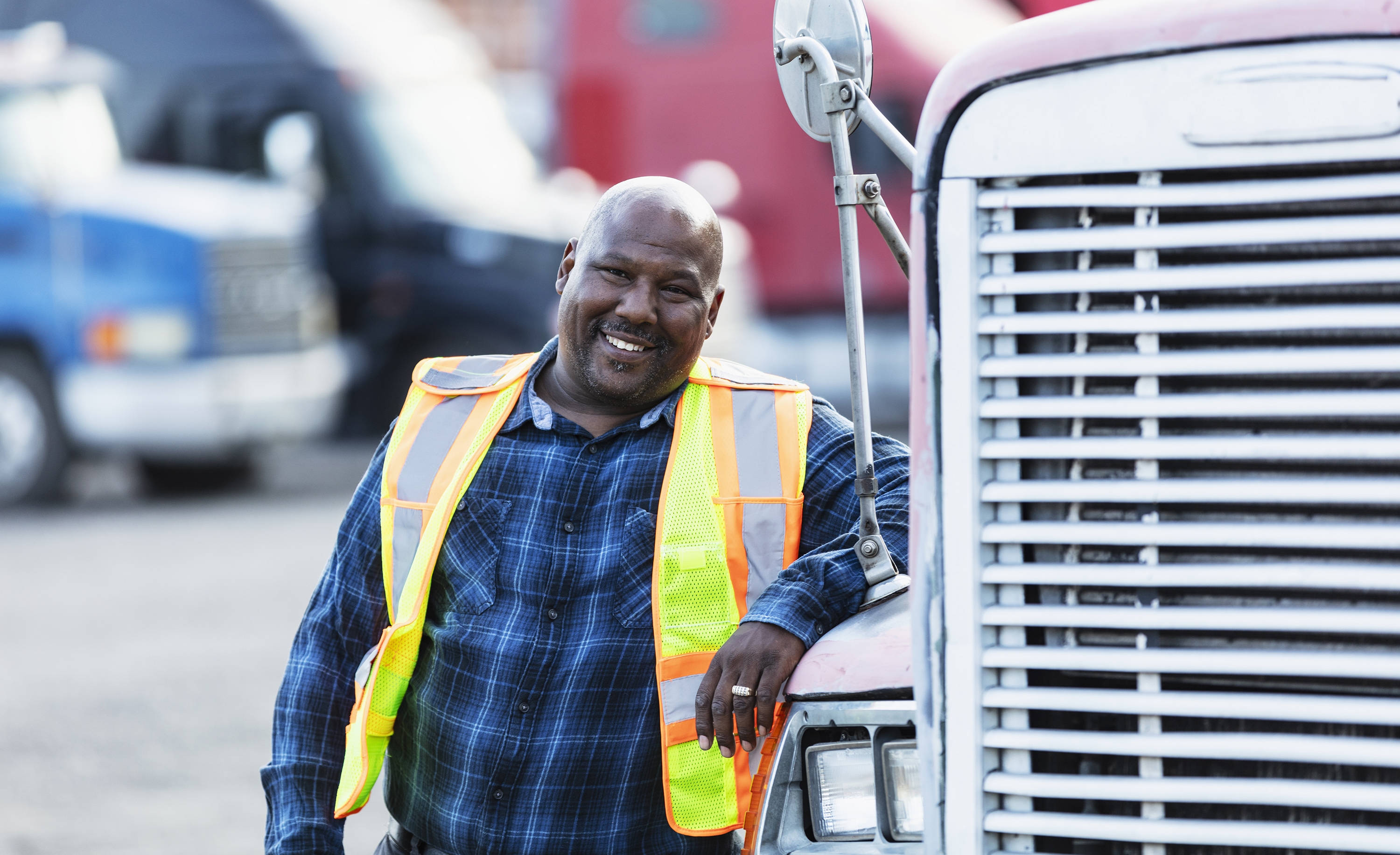Man leaning on front of semi truck