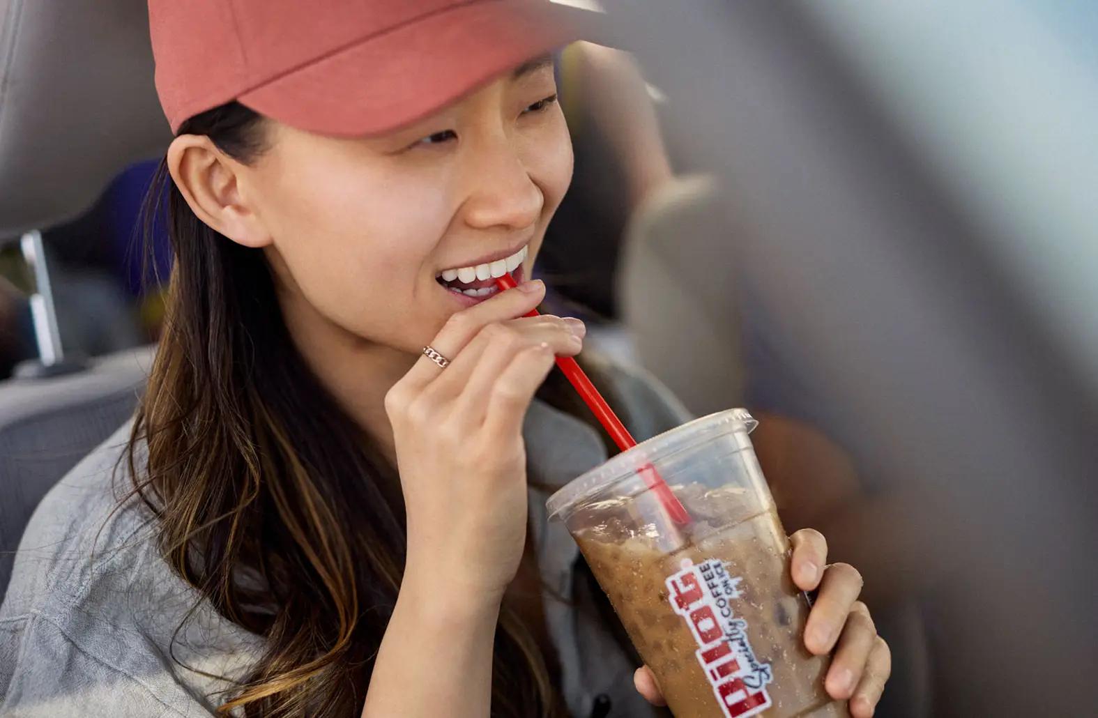A person sipping a Pilot iced coffee
