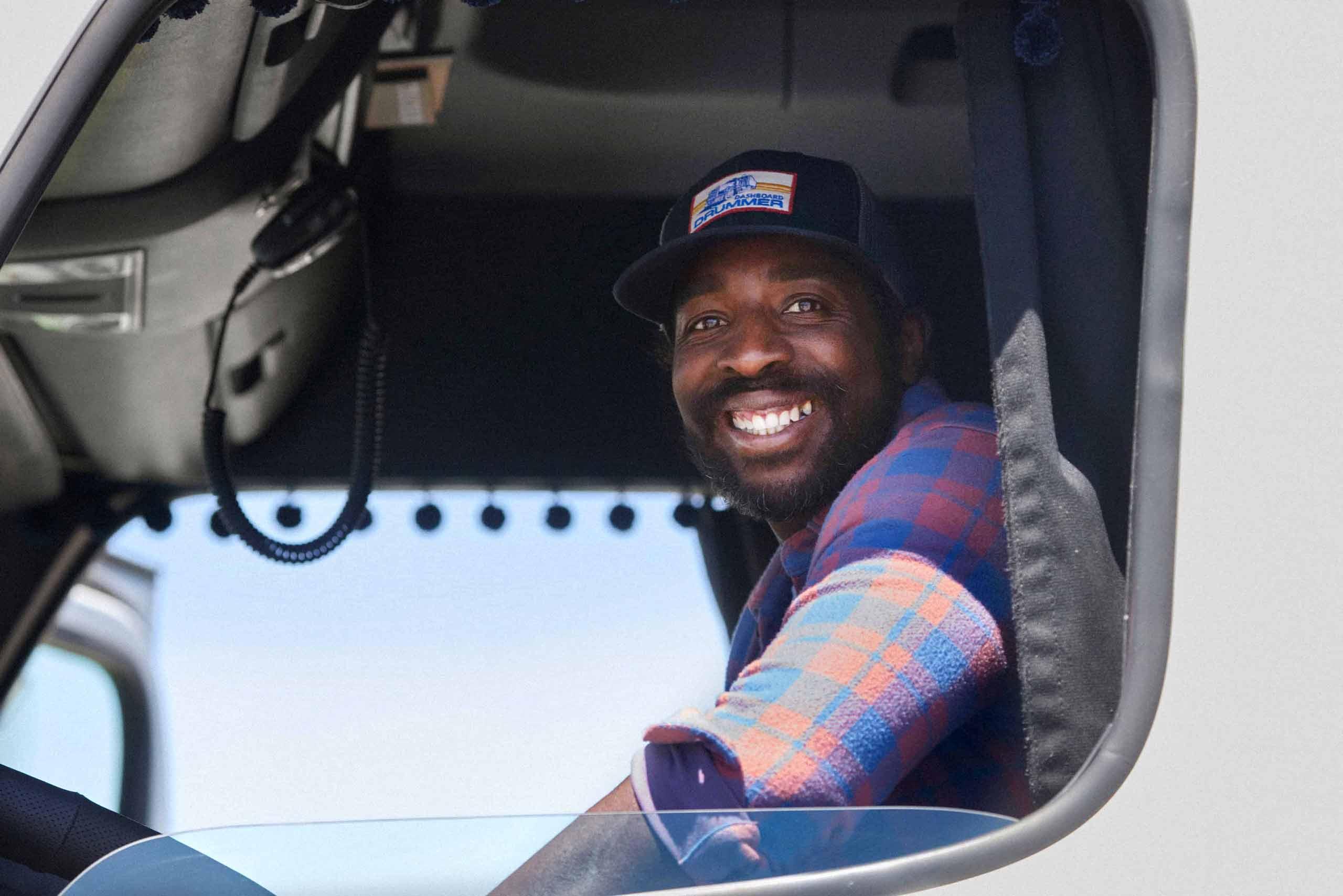 Pro Driver Smiling from Cab of Truck