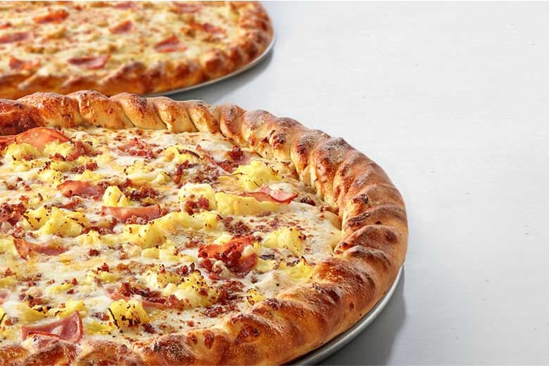 Hand-roped pizzas with pineapple and ham topping