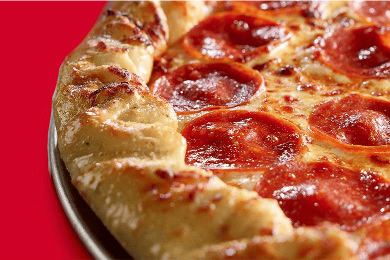 Close-up of a pepperoni pizza with glossy red tomato sauce, melted cheese, and sliced pepperoni on a thick golden-brown crust, served on a metal pan