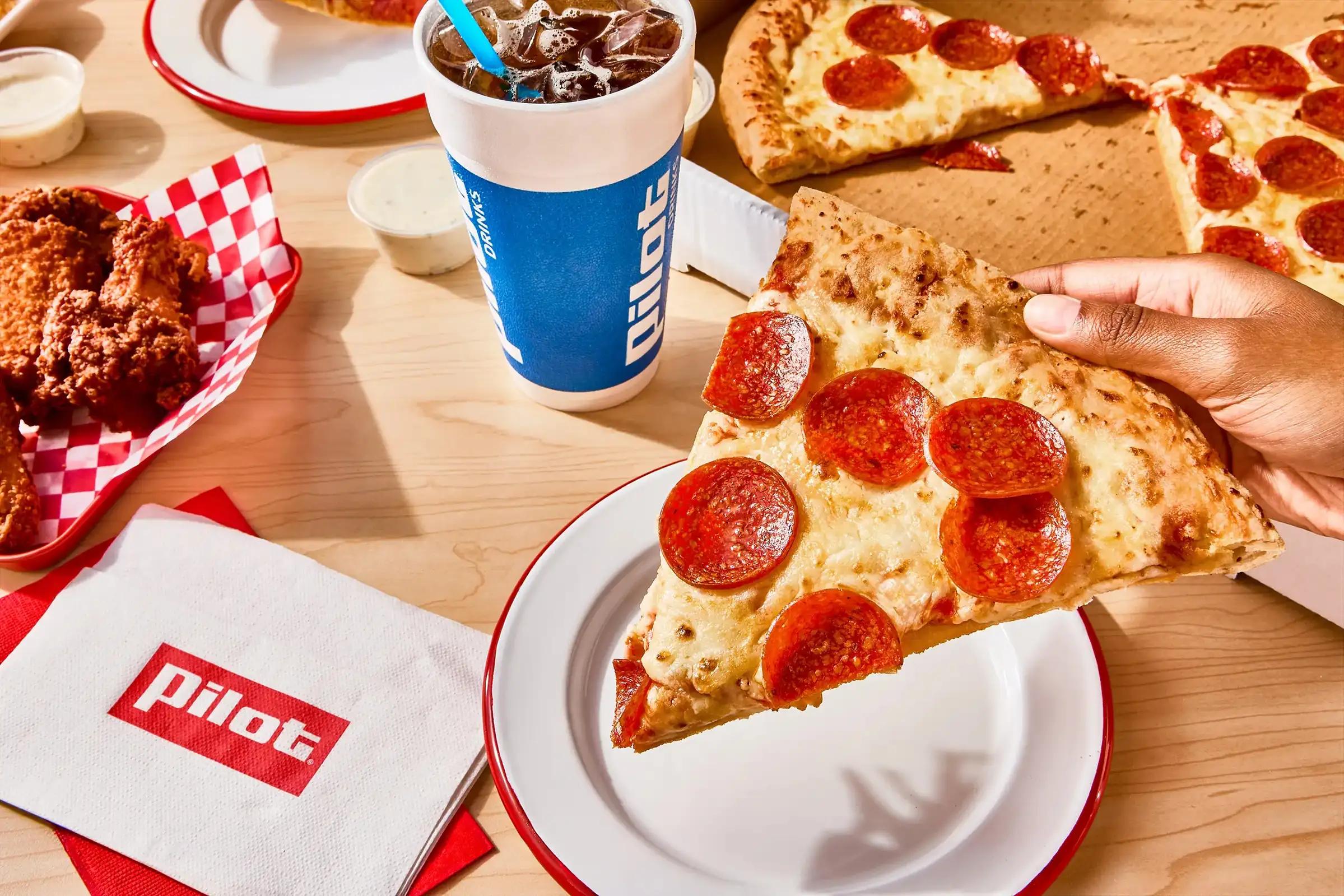 Pilot Pizza with wings and a drink