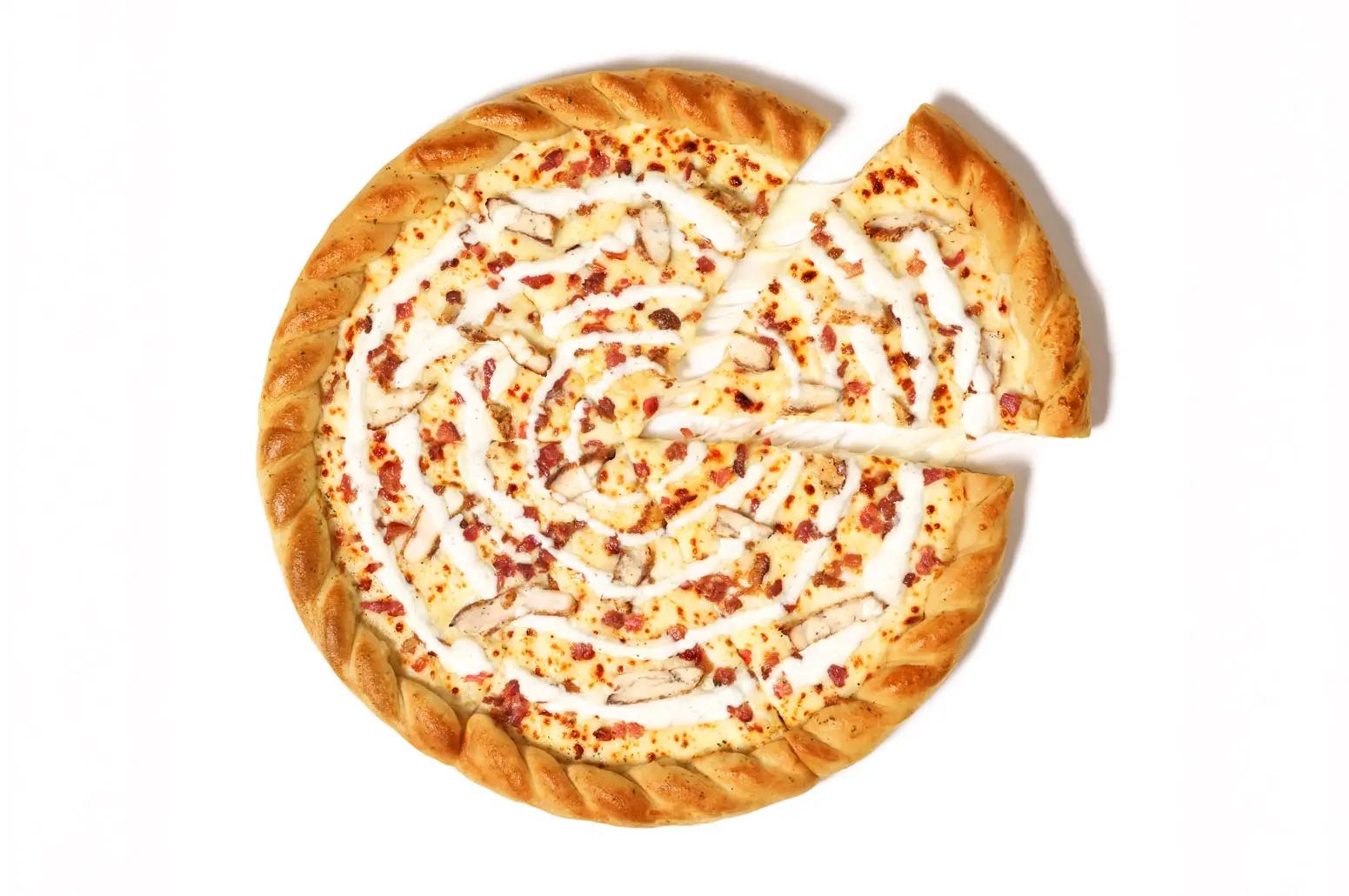 a chicken bacon ranch pizza with roped crust and a slice removed