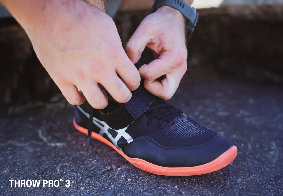 ASICS Athlete Payton Otterdahl tying his black asics shoes